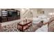 Cozy living room with a TV entertainment center, sofas, and a patterned rug at 10653 E 163Rd Ct, Brighton, CO 80602