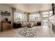 Beautiful living room with large windows, neutral decor, fireplace, and backyard access at 10653 E 163Rd Ct, Brighton, CO 80602