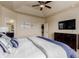 Comfortable main bedroom featuring a tray ceiling, ceiling fan, and ensuite bathroom at 10653 E 163Rd Ct, Brighton, CO 80602