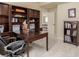 Inviting home office features a built-in desk, shelving, and natural light at 10653 E 163Rd Ct, Brighton, CO 80602