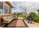 View of a covered patio with comfortable seating and an outdoor grill at 10653 E 163Rd Ct, Brighton, CO 80602