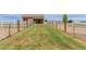 Backyard view showing spacious grass area, fencing, and mature trees at 10653 E 163Rd Ct, Brighton, CO 80602