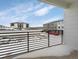 Private balcony overlooking parking lot and other buildings at 6153 N Ceylon St # 201, Denver, CO 80249