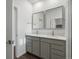 Modern bathroom with double vanity and walk-in shower at 6153 N Ceylon St # 201, Denver, CO 80249