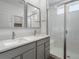 Modern bathroom with double vanity and walk-in shower at 6153 N Ceylon St # 201, Denver, CO 80249