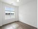 Bright bedroom with large window and wood-look floors at 6153 N Ceylon St # 201, Denver, CO 80249