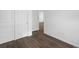Spacious bedroom with wood-look flooring and access to hallway at 6153 N Ceylon St # 201, Denver, CO 80249