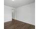 Bright bedroom with wood-look floors and access to hallway at 6153 N Ceylon St # 201, Denver, CO 80249