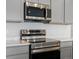 Stainless steel LG microwave and range with smooth cooktop at 6153 N Ceylon St # 201, Denver, CO 80249