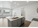 Modern kitchen with island, gray cabinets and stainless steel appliances at 6153 N Ceylon St # 201, Denver, CO 80249