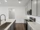 Modern kitchen with gray cabinets and stainless steel appliances at 6153 N Ceylon St # 201, Denver, CO 80249