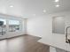 Bright living room with hardwood floors and access to a balcony at 6153 N Ceylon St # 201, Denver, CO 80249