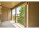Balcony with wood pillars offers a peaceful outdoor space with a view of trees and nearby buildings at 7493 S Quail Cir # 928, Littleton, CO 80127