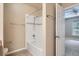 Clean bathroom featuring a tub with shower, white tile, and modern fixtures at 7493 S Quail Cir # 928, Littleton, CO 80127