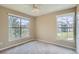 This bedroom has two large windows, a ceiling fan, and neutral carpeting at 7493 S Quail Cir # 928, Littleton, CO 80127
