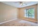 Bright bedroom featuring a ceiling fan, a large window, and neutral carpet at 7493 S Quail Cir # 928, Littleton, CO 80127