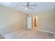 Bedroom with neutral walls, carpet, a ceiling fan and adjoining bath at 7493 S Quail Cir # 928, Littleton, CO 80127
