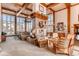 Clubhouse living room featuring coffered ceilings and a stone fireplace at 7493 S Quail Cir # 928, Littleton, CO 80127