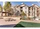Exterior courtyard featuring BBQ grill, picnic tables, and green space at 7493 S Quail Cir # 928, Littleton, CO 80127