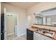 Kitchen featuring stainless steel sink, black dishwasher, and access to the laundry area at 7493 S Quail Cir # 928, Littleton, CO 80127