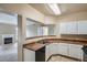 This kitchen offers white cabinets and an open layout with view into the living room at 7493 S Quail Cir # 928, Littleton, CO 80127