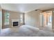 Spacious living room featuring a fireplace, natural light, and neutral carpet at 7493 S Quail Cir # 928, Littleton, CO 80127