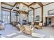 Bright living room with wooden beams, large windows, stone fireplace, and comfortable seating arrangement at 7493 S Quail Cir # 928, Littleton, CO 80127