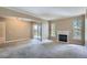 This living room has a fireplace, sliding glass doors, and neutral colored carpet at 7493 S Quail Cir # 928, Littleton, CO 80127