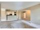 Open-concept living room featuring a kitchen with white cabinets and neutral paint at 7493 S Quail Cir # 928, Littleton, CO 80127