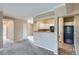 Open-concept living room featuring a kitchen with white cabinets and neutral paint at 7493 S Quail Cir # 928, Littleton, CO 80127