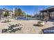 Community pool with lounge chairs, picnic tables, and covered seating, ideal for relaxation and socializing at 7493 S Quail Cir # 928, Littleton, CO 80127