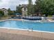 Community swimming pool with lounge chairs and a water feature, perfect for relaxing and enjoying the outdoors at 7493 S Quail Cir # 928, Littleton, CO 80127