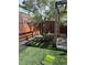 Zen backyard with artificial turf and custom-designed metal and wooden fixtures, great for a relaxing outdoor space at 3270 Depew St, Wheat Ridge, CO 80212