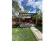 Beautiful backyard featuring a custom pergola, artificial turf, and a charming stone path for a serene outdoor retreat at 3270 Depew St, Wheat Ridge, CO 80212
