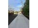 Long concrete driveway leading to a home with a wooden fence and landscaped sides at 3270 Depew St, Wheat Ridge, CO 80212