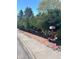 Attractive front yard with manicured bushes, red brick border, and black mulch for a clean curb appeal at 3270 Depew St, Wheat Ridge, CO 80212