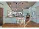 Well-lit kitchen with wooden counters and breakfast bar featuring modern stools and stainless steel appliances at 3270 Depew St, Wheat Ridge, CO 80212