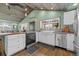 Modern kitchen showcasing stainless steel appliances, a farmhouse sink, and a window overlooking the backyard at 3270 Depew St, Wheat Ridge, CO 80212