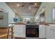 Modern kitchen with stainless steel oven, wooden counter, and view into adjacent living room with comfortable seating at 3270 Depew St, Wheat Ridge, CO 80212