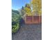 Recently mulched groundcover and a privacy fence encloses the back yard for a clean, secluded outdoor space at 3270 Depew St, Wheat Ridge, CO 80212