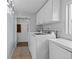 Bright laundry room features modern washer, dryer, and white cabinets for ample storage at 3270 Depew St, Wheat Ridge, CO 80212