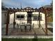 Inviting backyard with a pergola-covered patio and outdoor dining set, perfect for summer gatherings and entertaining guests at 3270 Depew St, Wheat Ridge, CO 80212