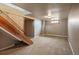 Basement features carpeted floor, wooden stairs with railing, and a small window at 4731 S Acoma St, Englewood, CO 80110