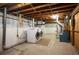 Basement laundry area with exposed ceiling, modern washer/dryer, and utility systems at 4731 S Acoma St, Englewood, CO 80110
