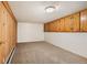 Basement storage room features wood-paneled walls, carpet flooring, and built in shelves at 4731 S Acoma St, Englewood, CO 80110