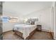 Bedroom with two windows, floral bedding, carpeted floors and a radiator at 4731 S Acoma St, Englewood, CO 80110