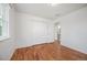 Bright bedroom featuring hardwood floors, neutral walls, and double closet with bifold doors at 4731 S Acoma St, Englewood, CO 80110