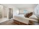 Bedroom with floral bedding, carpeted floors, glass block and a window at 4731 S Acoma St, Englewood, CO 80110