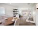 Dining room with seating for four, wainscoting and view to backyard through large windows at 4731 S Acoma St, Englewood, CO 80110