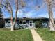 Charming single-story home with a well-maintained lawn and mature trees in a peaceful neighborhood at 4731 S Acoma St, Englewood, CO 80110